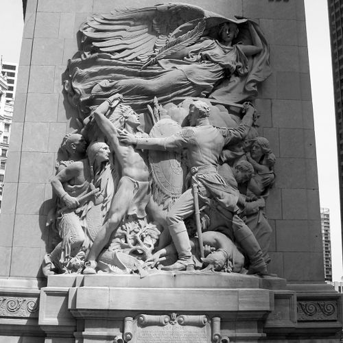 The four monumental relief sculptures on the Michigan Avenue-facing sides of each of the four Bridgehouses at DuSable Bridge, show episodes representing the founding and struggle to establish and rebuild Chicago. Carved in high relief, the four scenes are highly idealized and lofty visual rhetoric; each includes a female personification of winged victory or glory that floats above multi-figured illustrations of conflict, unity or struggle to overcome adversity.