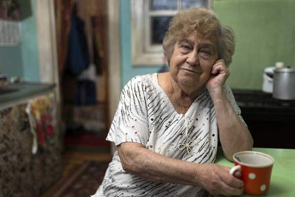 Compass image of an older women drinking coffee
