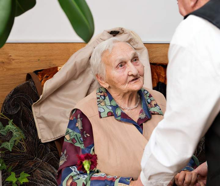 Senior woman being helped up 