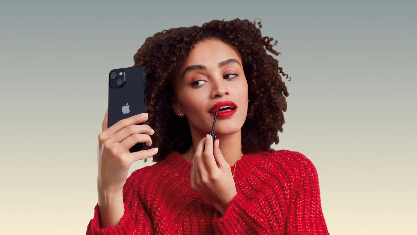 woman with iphone wearing make up
