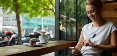 Frau im Cafe mit Smartphone