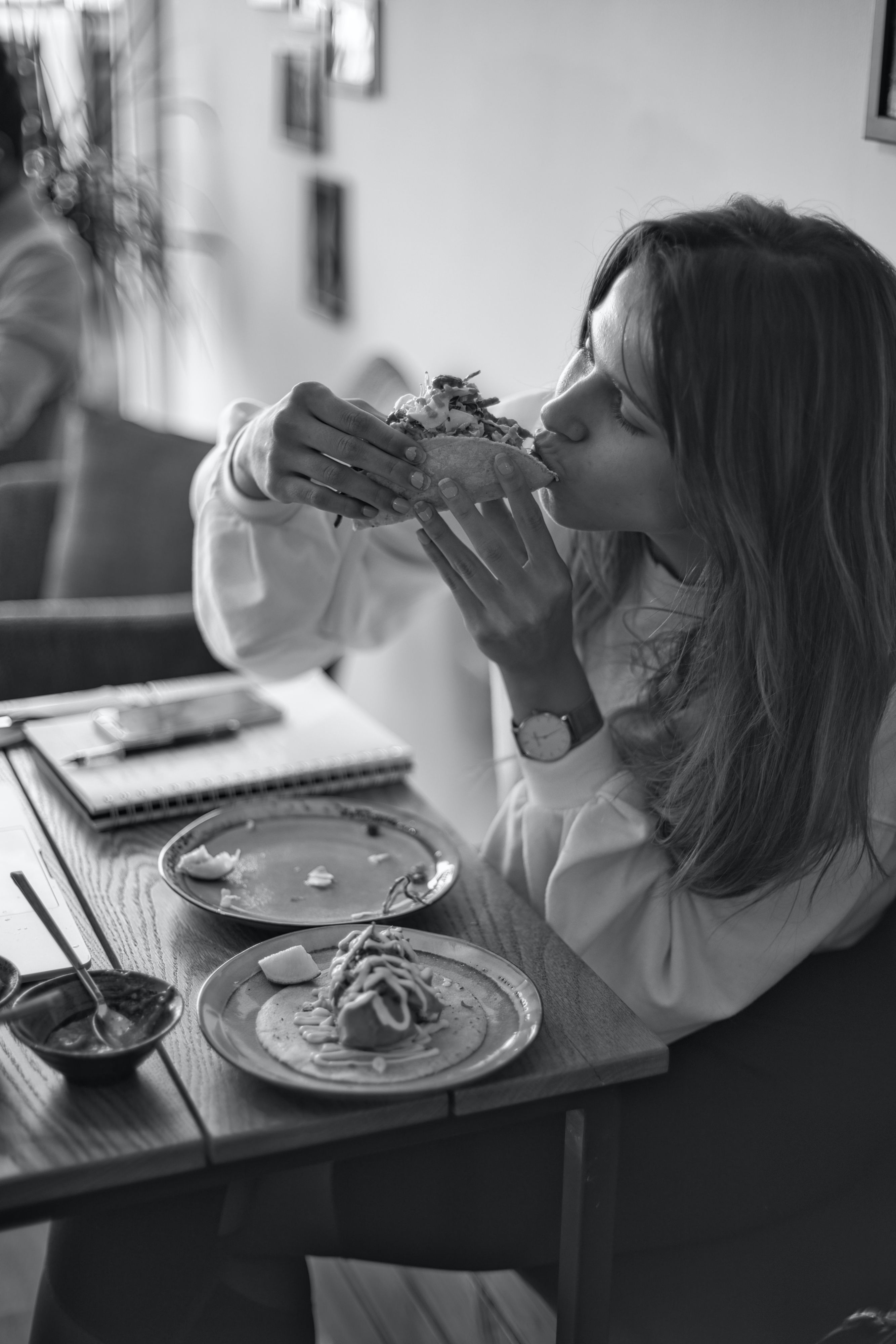 Woman eating tacos inside an office for lunch