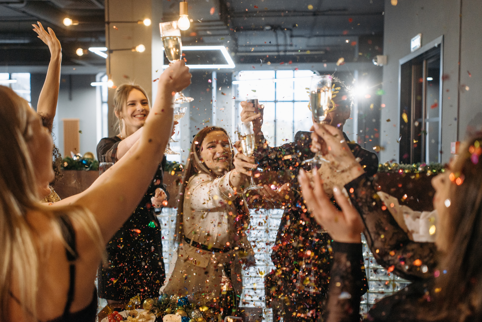 Team members cheers champagne happy at company holiday gathering