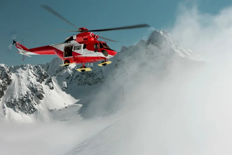 Záchranársky vrtuľník v zasnežených horách