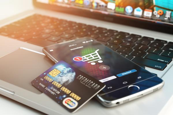 platobná karta a mobil položené na notebooku