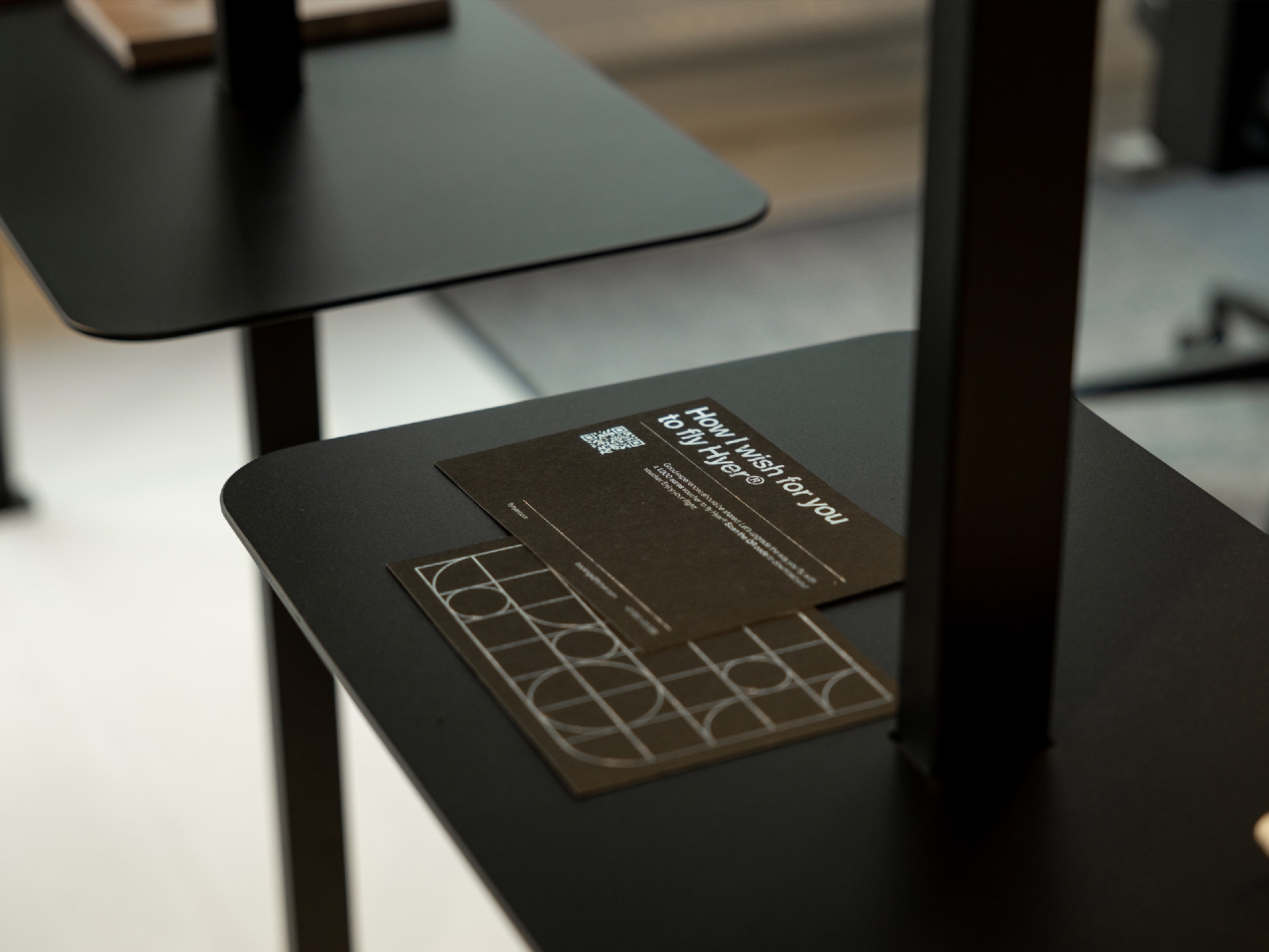 Business cards from Hyer on a black steel cabinet in the office.