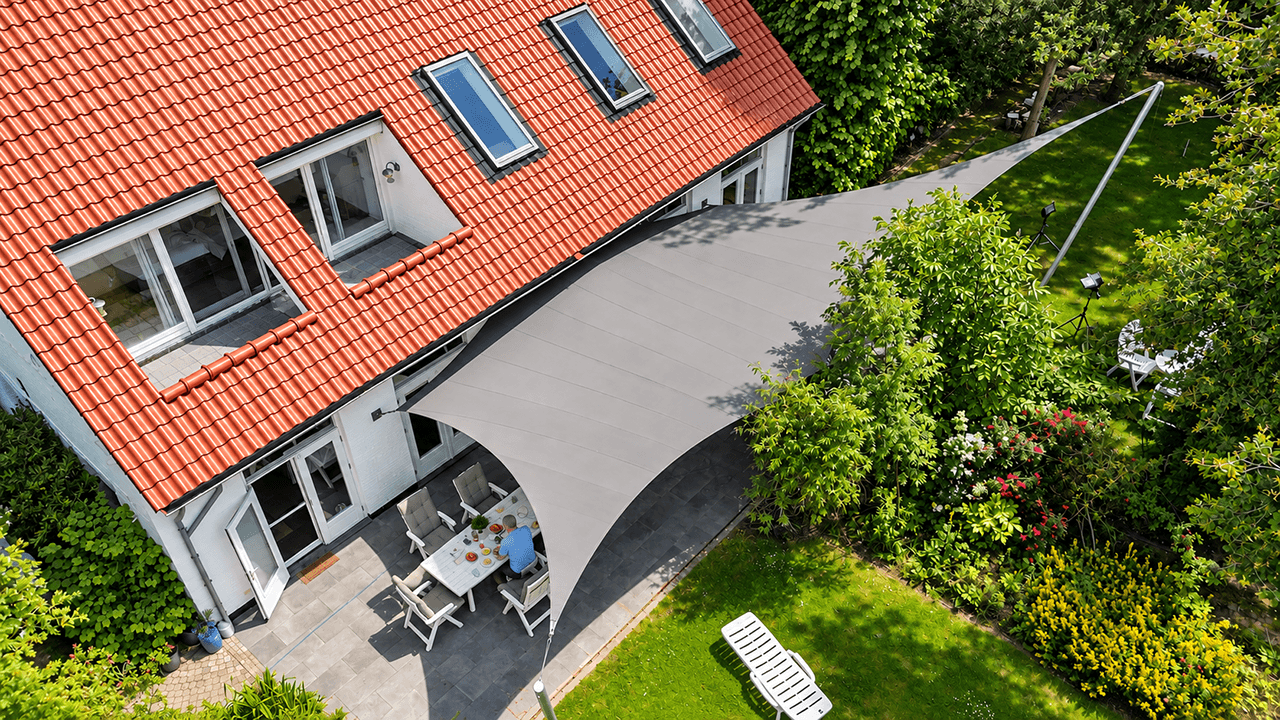 Groot maatwerk zonnedoek van Mobuline boven een terras aan huis voor schaduw en comfortabel buitenleven.