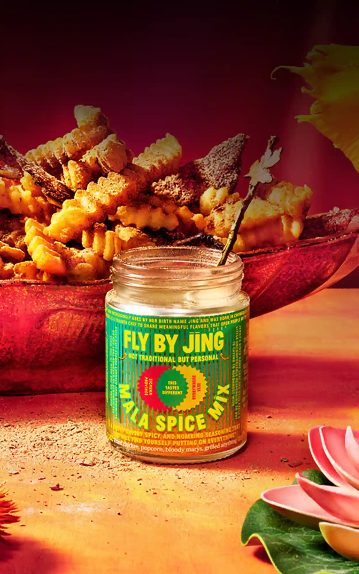 Mala Spice Mix jar with a bowl of fries in the back