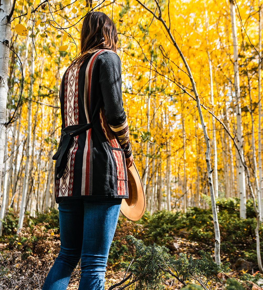 woman standing in autumn forest