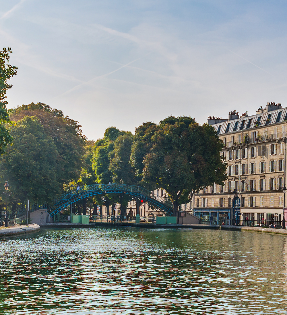 turquoise metal bridge over canal in paris 