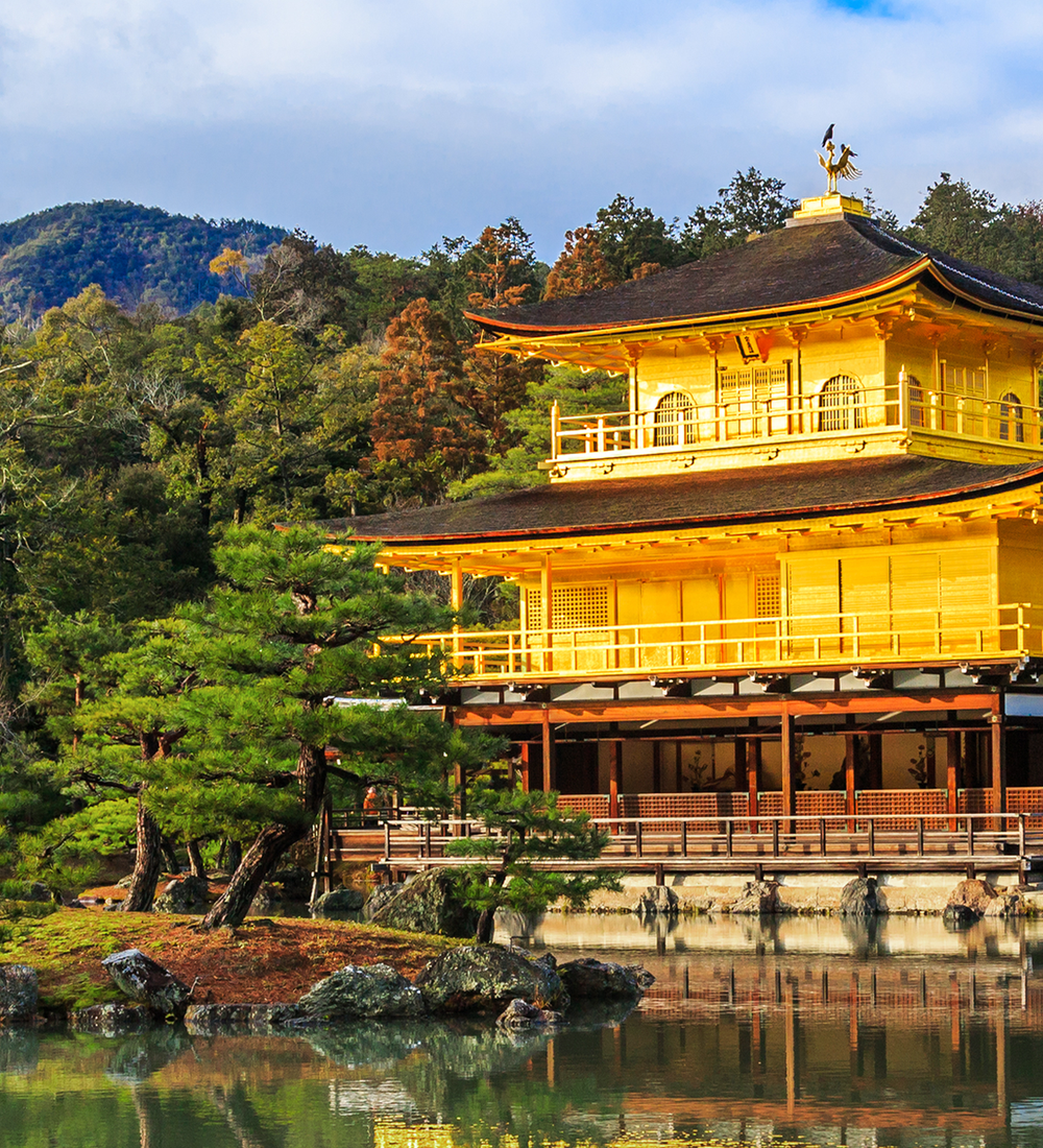 bright yellow temple of kinkaku ji on a river in kyoto japan