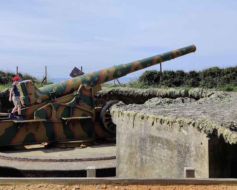 Anton exploring a French cannon brought to the island by the Germans