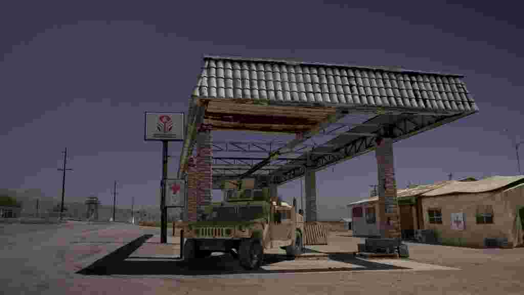 Army vehicle at an abandoned petrol station