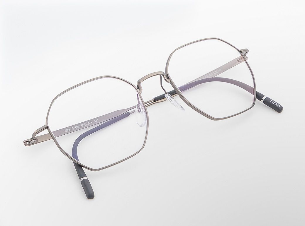 Pure Visionary titanium eyeglasses with an ultra-thin profile wire frame in a soft metallic finish, geometric lenses, a sculpted bridge, and lightweight temples with black temple tips.