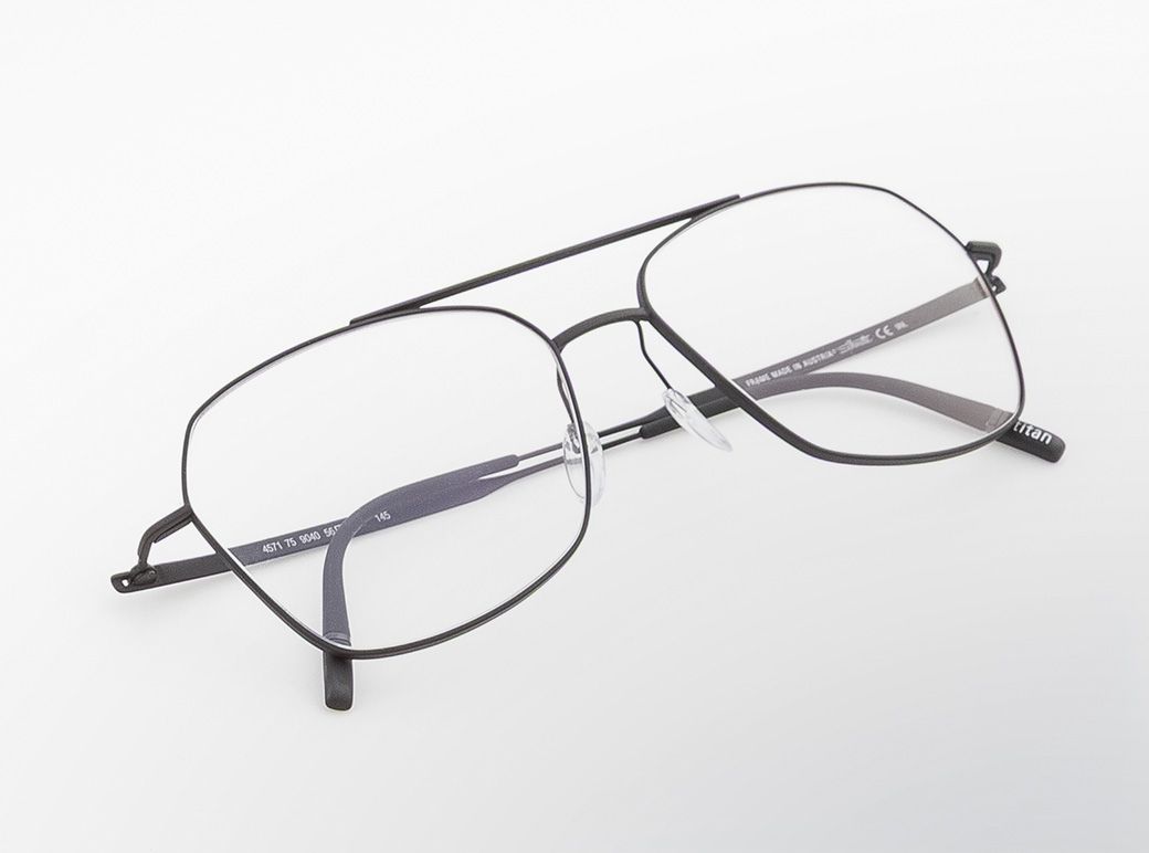 Pure Visionary titanium eyeglasses with an ultra-thin profile wire frame, softly geometric lenses, and a refined double bridge,