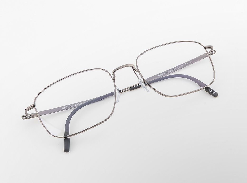 Pure Visionary titanium eyeglasses with a thin profile wire frame, geometric square lenses, and a sculpted bridge.