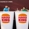 Two people in an ice baths designed as Burger King cups