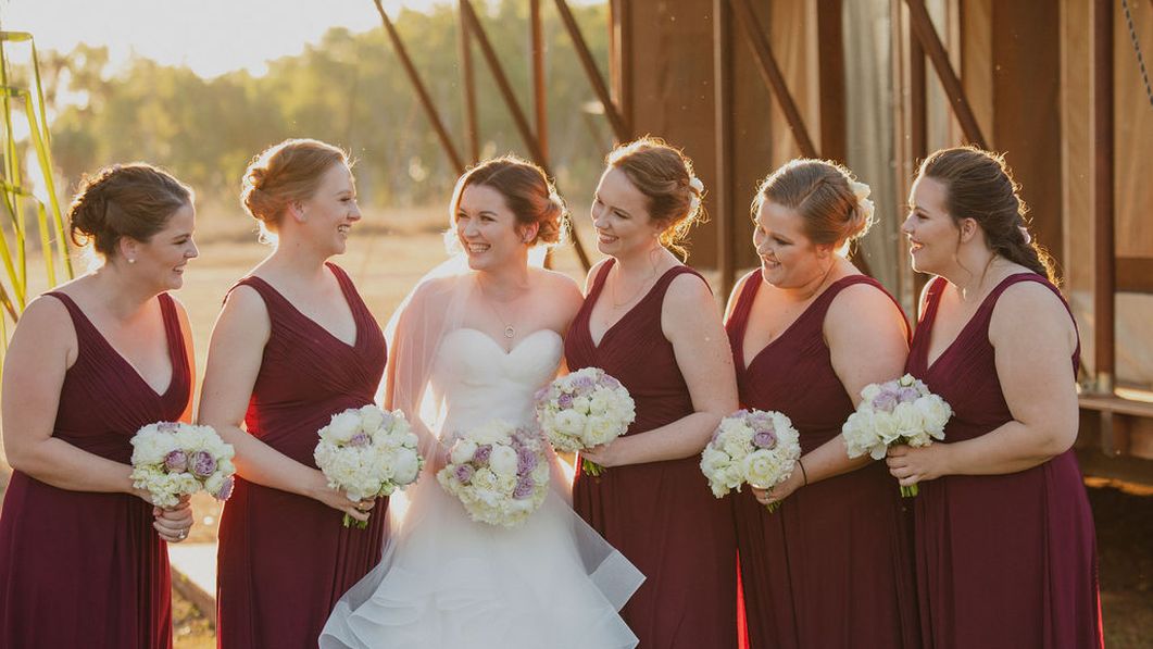 Bride surrounded by her bridesmaids at her wedding