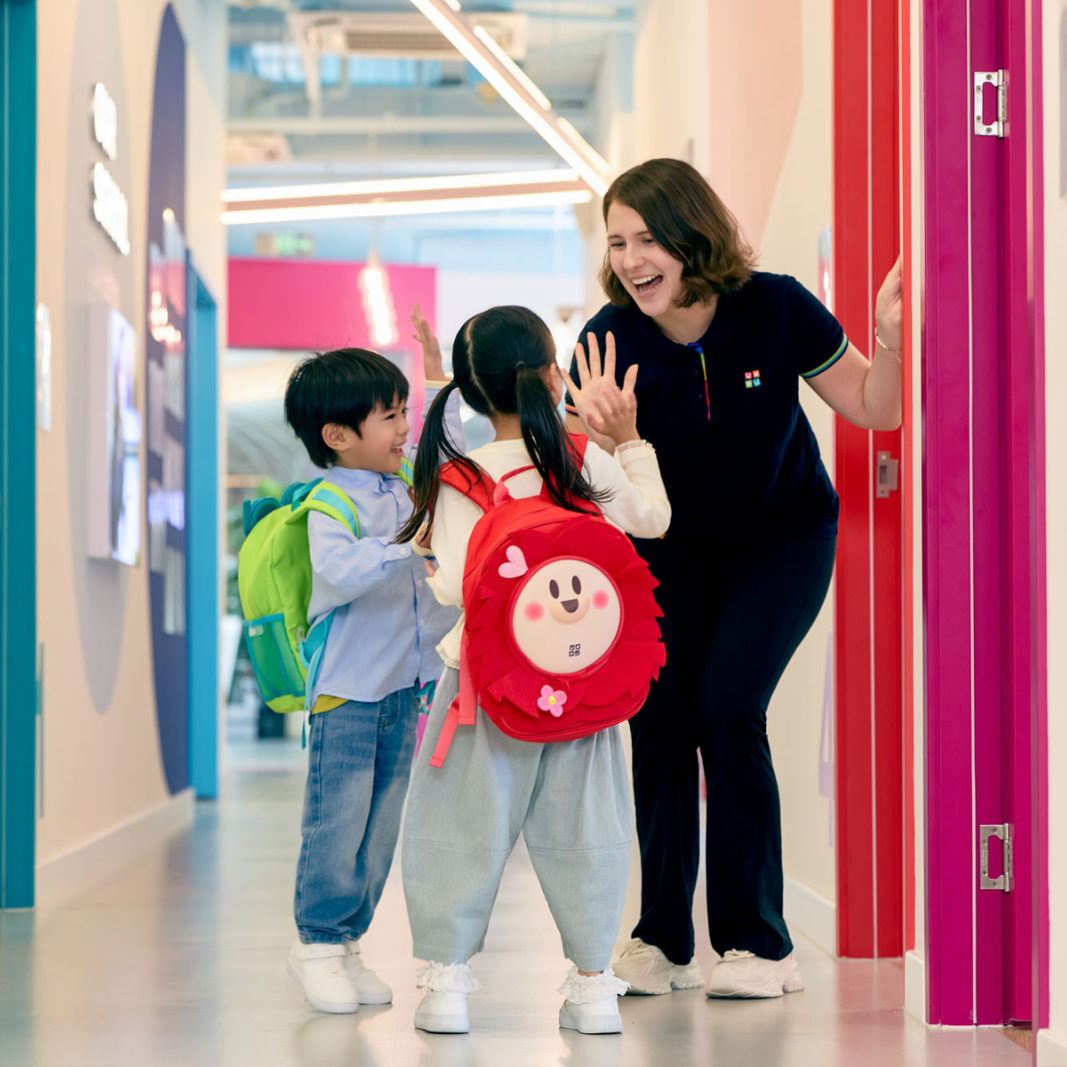 Teacher showing a flashcard to a student while smiling