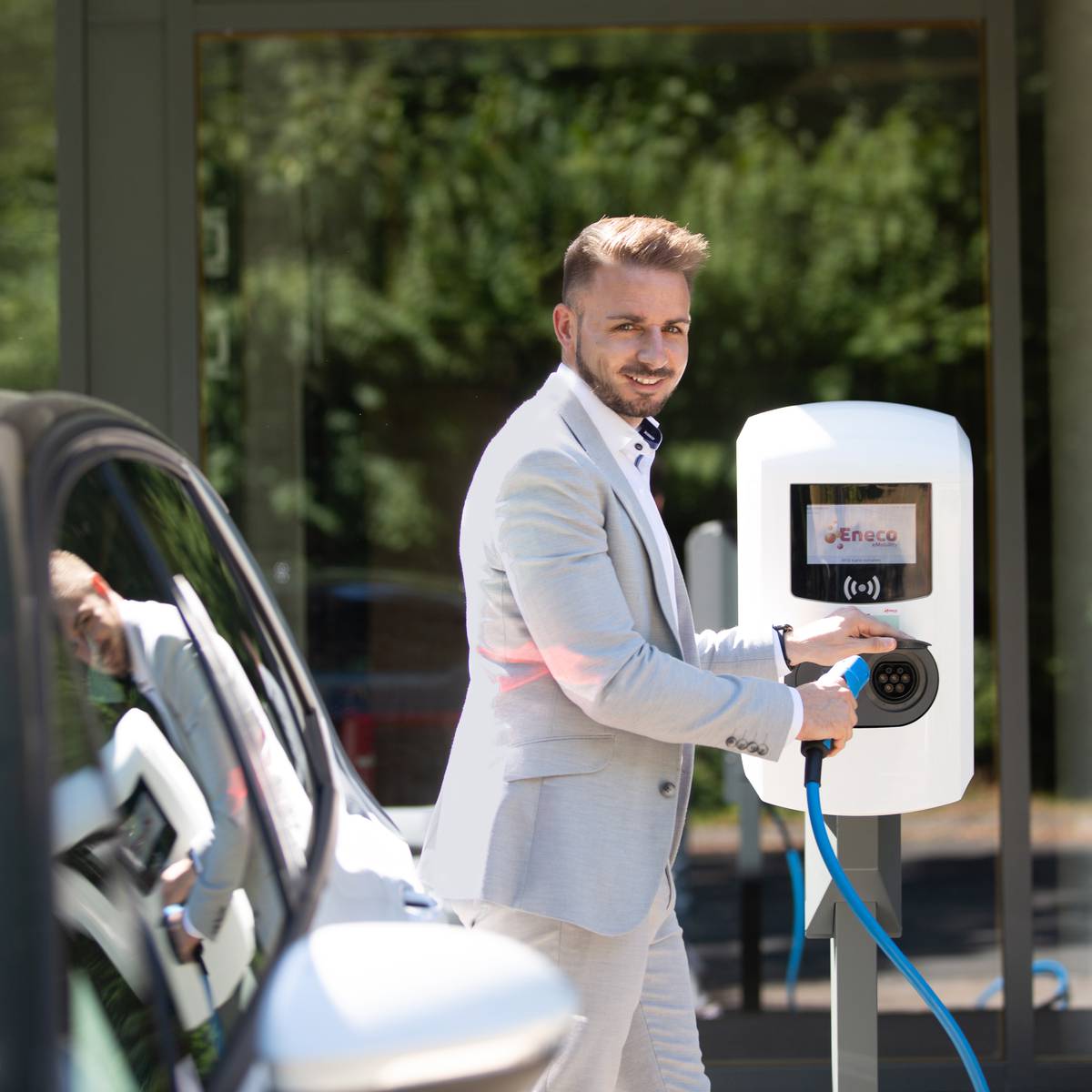 Man charging his e-car at work