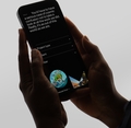 iPhone in hand with the Mooncolony website open