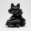TIDE cat leaning on pillow in black