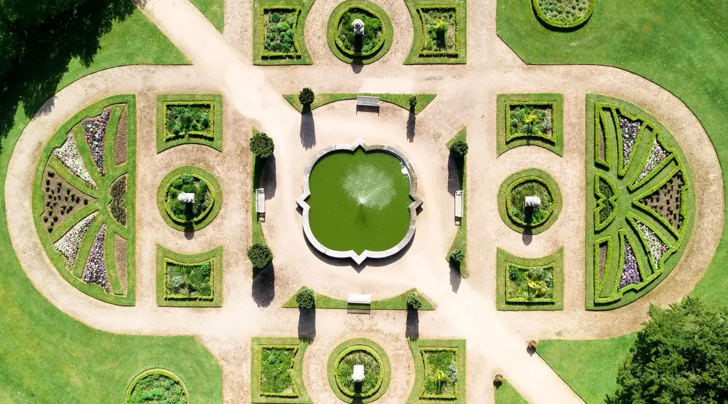 Overview aerial shot of the green Italian Gardens in an X design