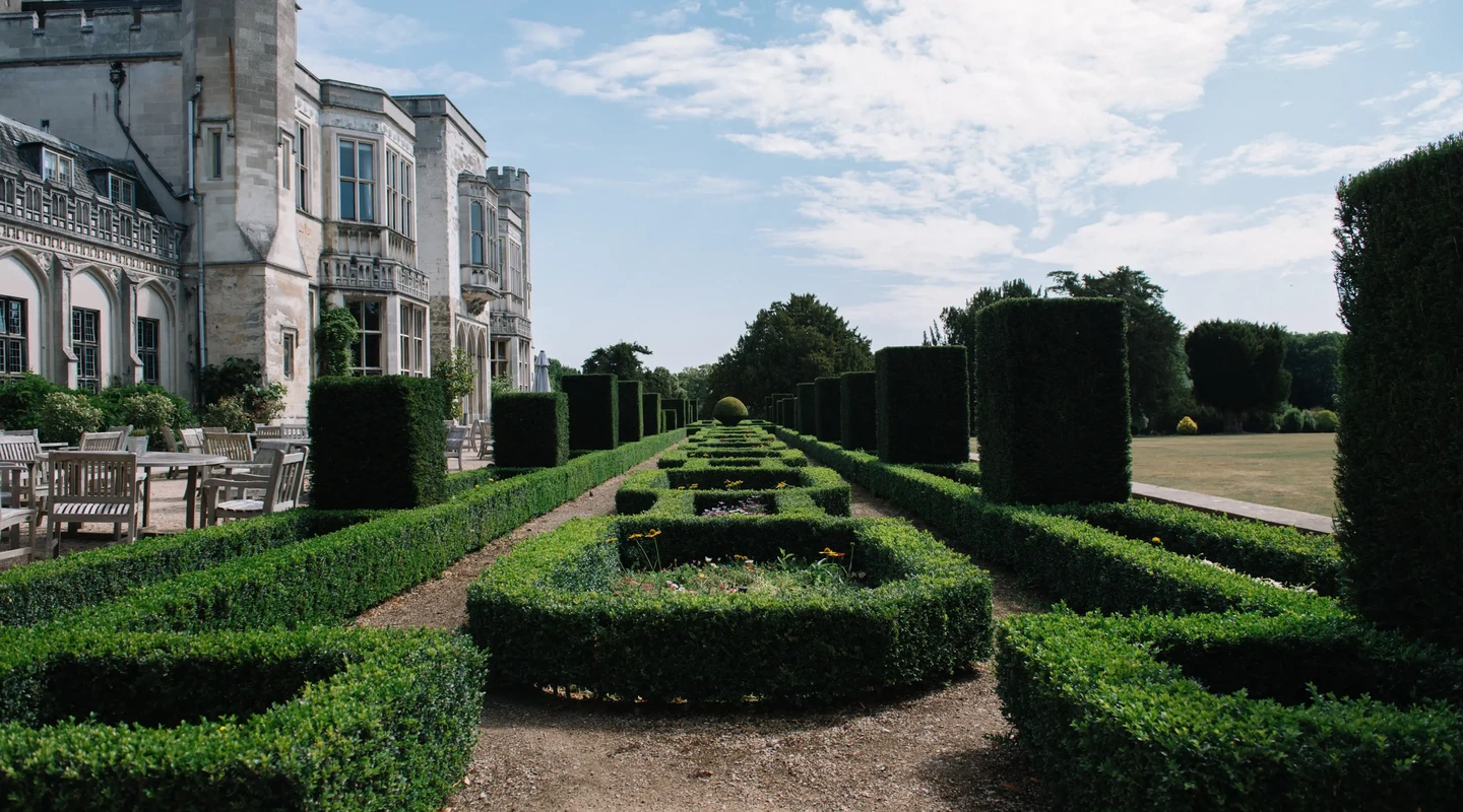 The south terrace with elaborately trimmed shrubbery and lawn tables