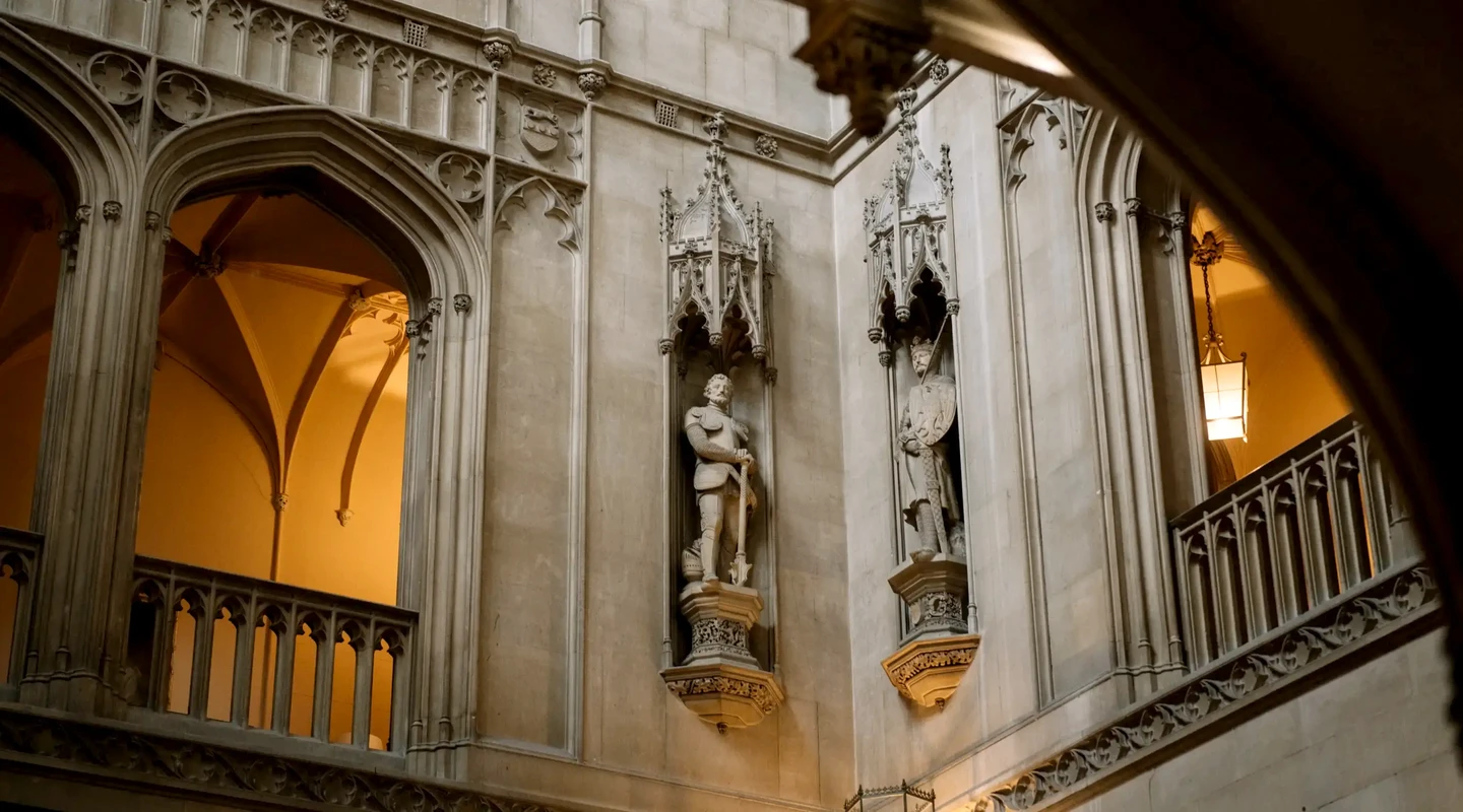Detail view of elaborate sculptures on the corner of the walls inside the main hall