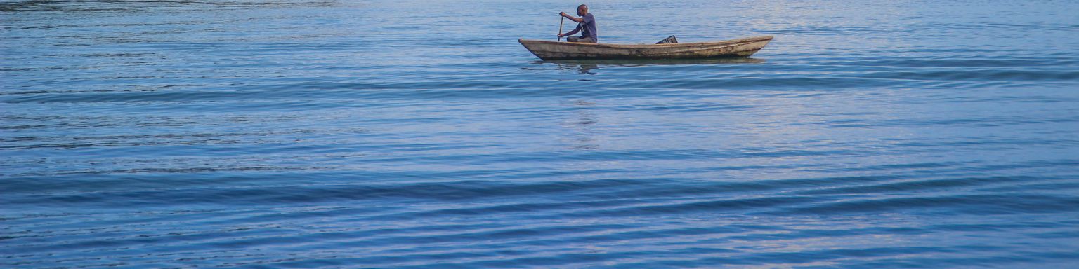 A fishing boat sails on Lake Tanganyika on a sunny day