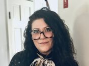 A headshot of Elisabetta with a slight smile inside in front of a white wall.