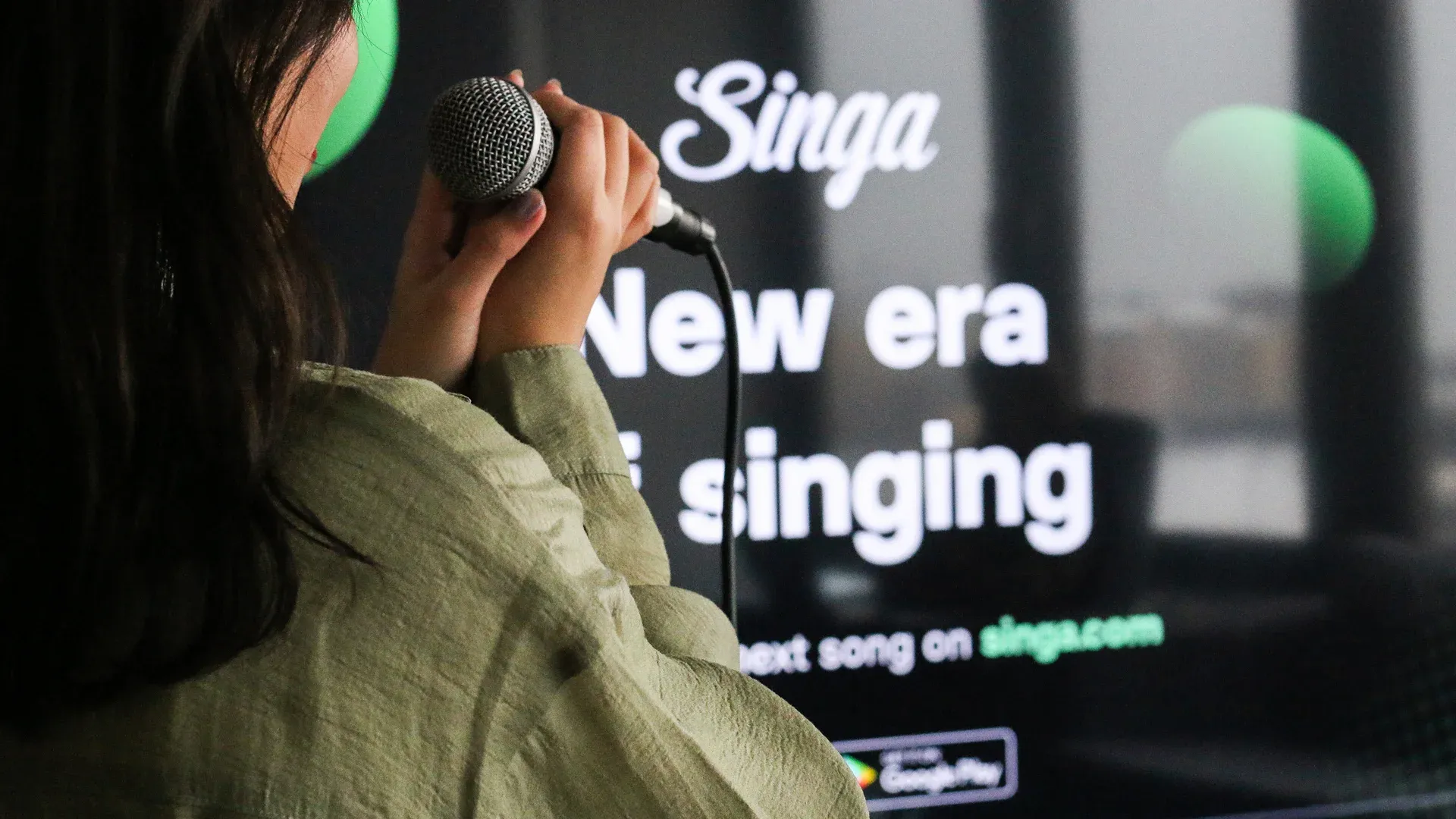 Woman in headphones beside Singa New era of singing tagline, banner hero of the Singa karaoke case study