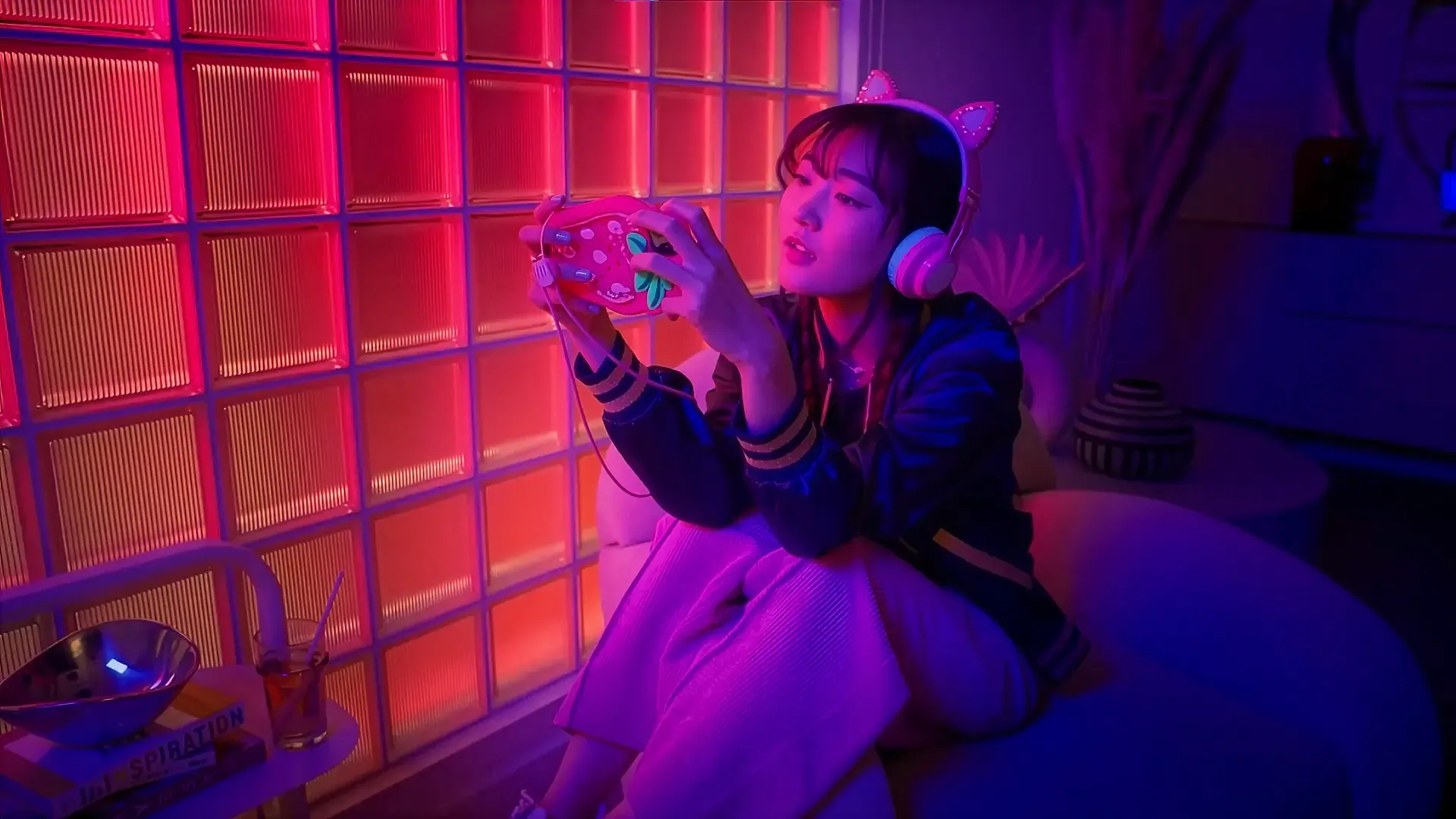Woman in cat-ear headphones playing a handheld game in a neon-lit room, from the MassiveMusic TikTok campaign