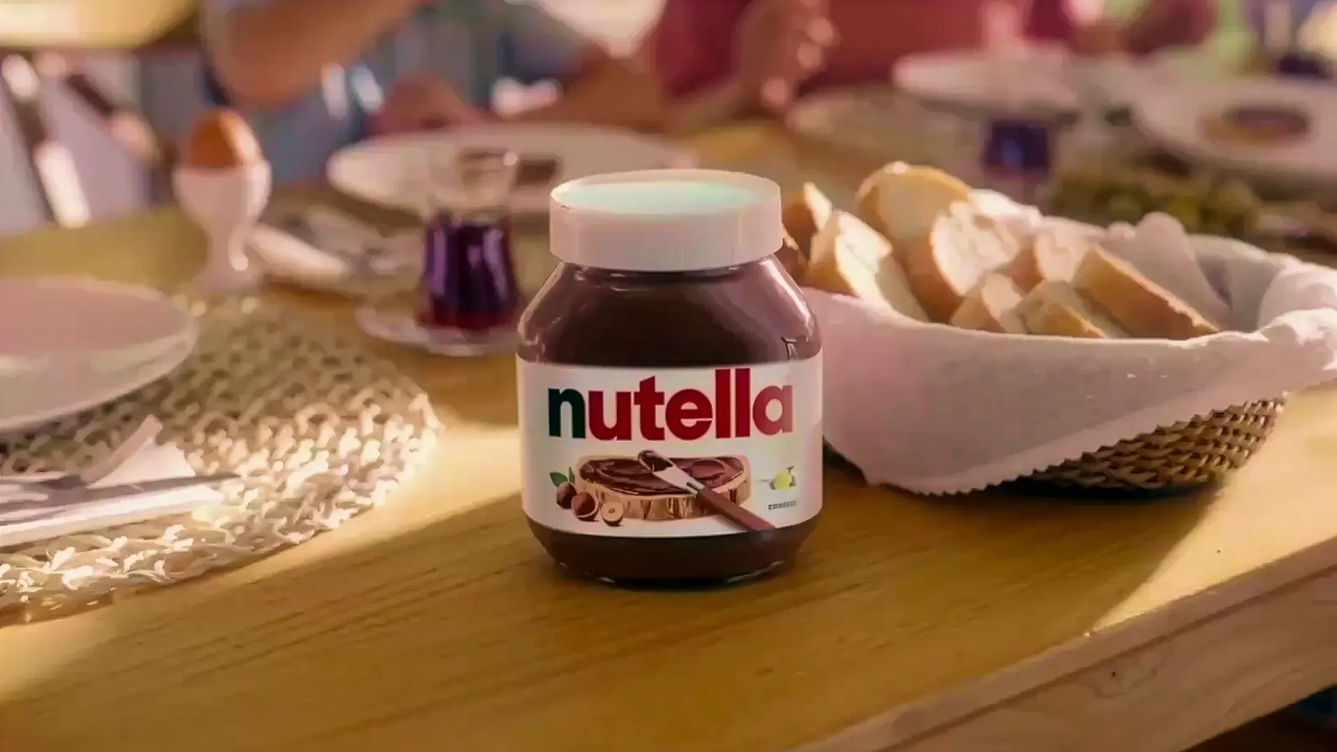 Jar of Nutella on a set breakfast table with plates and pastries, from the Sound of Nutella campaign