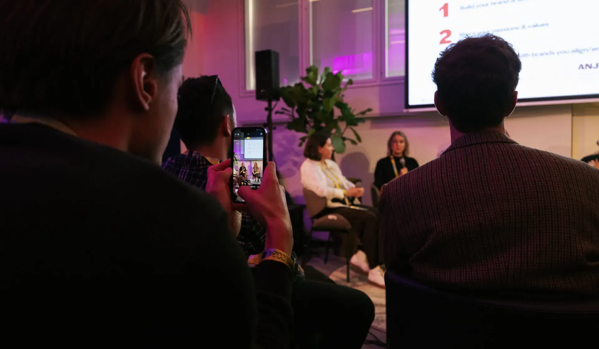 Attendee filming the Beyond Streaming panel talk on a phone at ADE