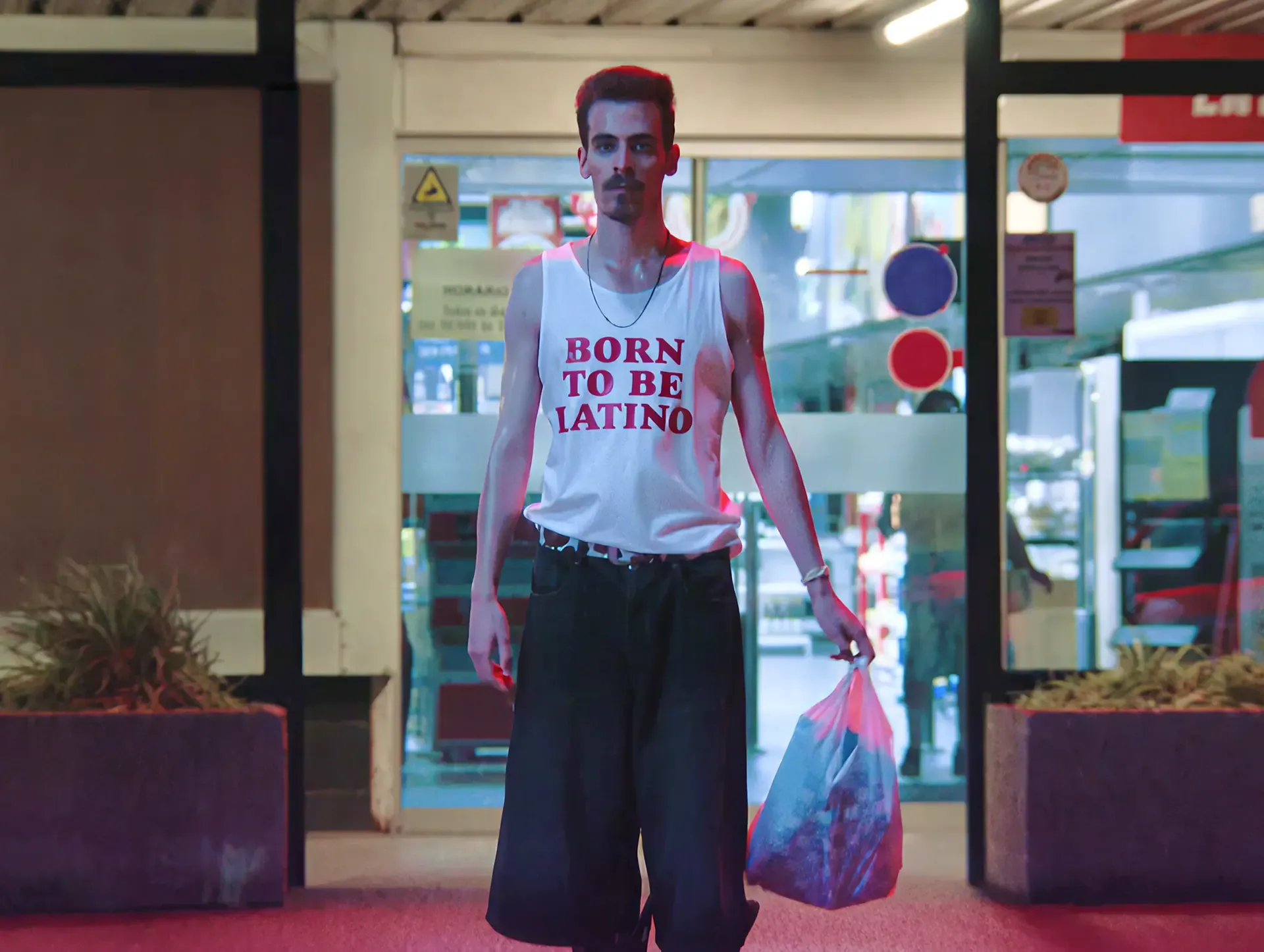 Man in a Born to be Latino shirt at a shop doorway, from the MassiveMusic Desperados campaign