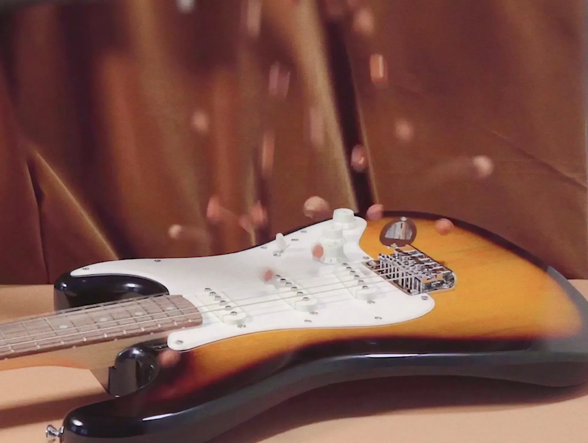 Close-up of a sunburst electric guitar on fabric, from the Sound of Nutella campaign