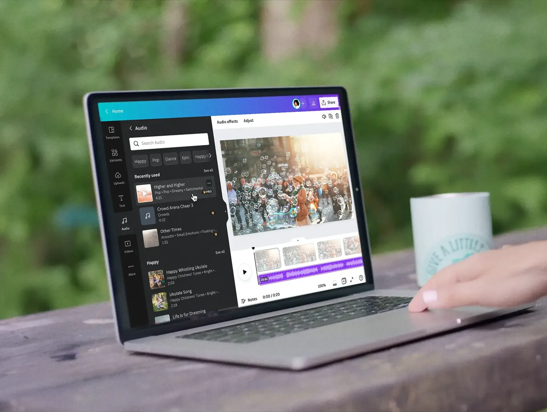 Laptop outdoors showing Canva's music library interface, with a user browsing licensed tracks to add to a visual design.