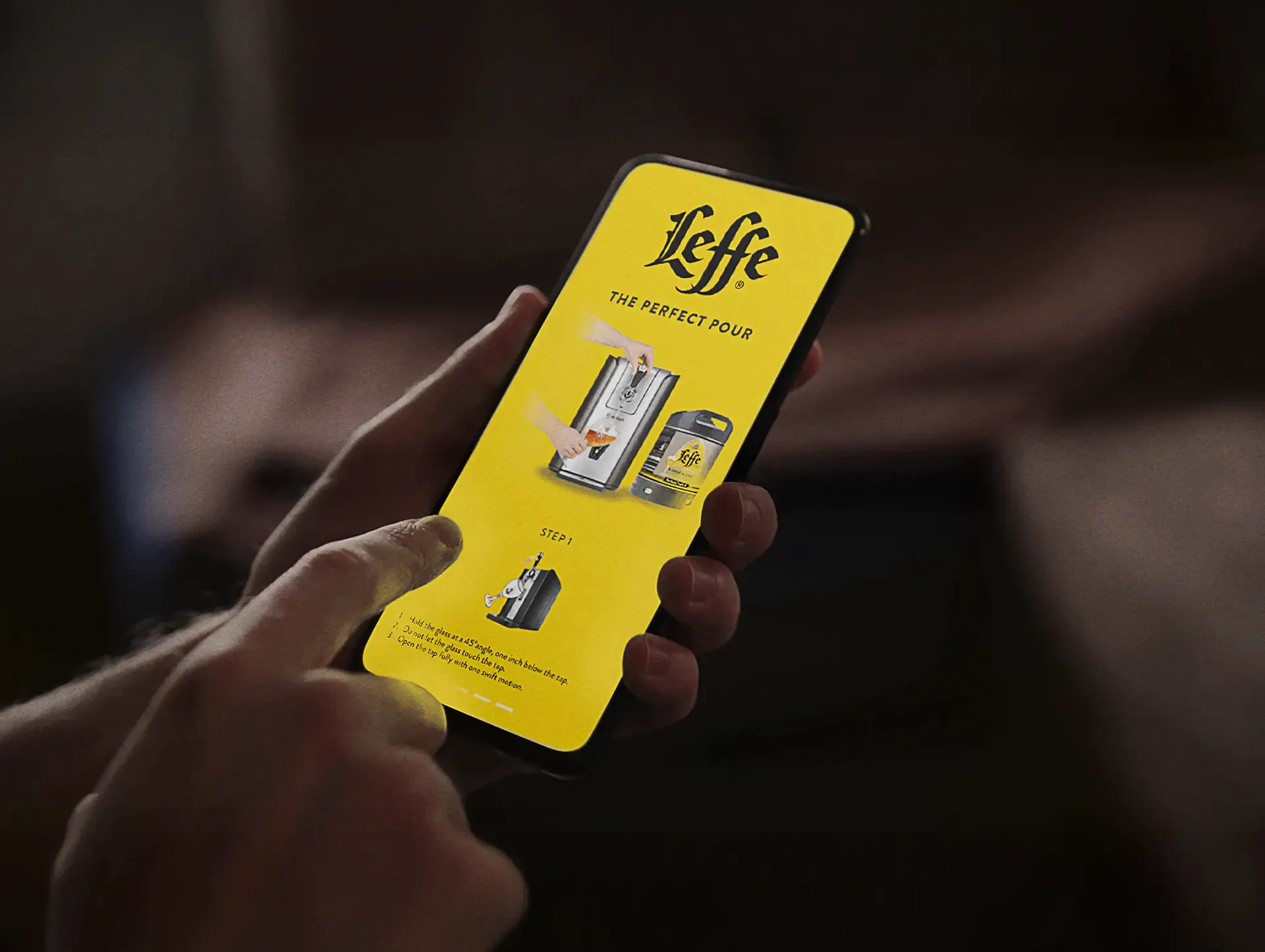 Hand holding a phone showing Leffe branding in a dark setting, from the Sound of Leffe campaign