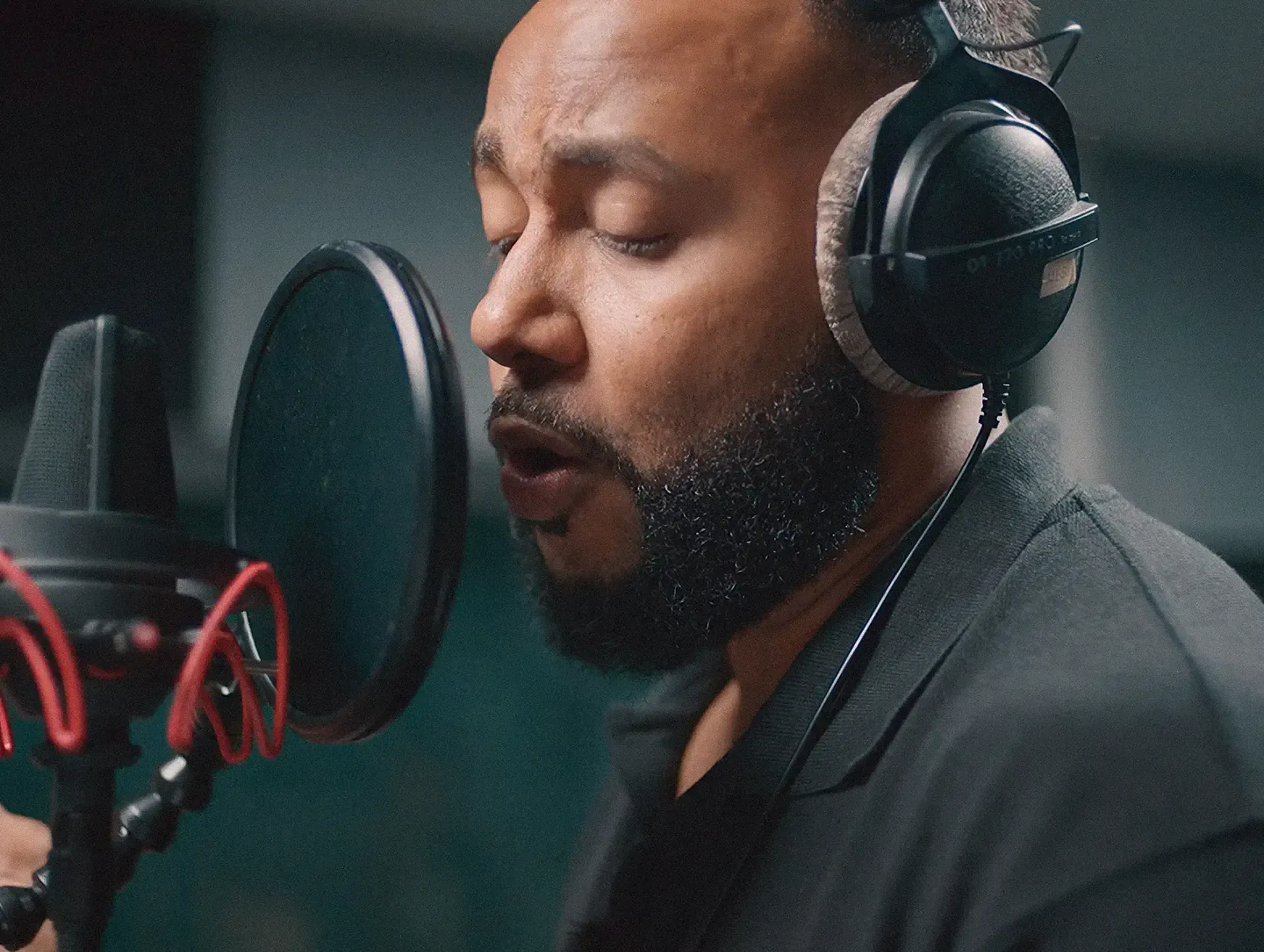 Singer with headphones recording vocals at a studio microphone, from the Sound of Fiji Airways campaign