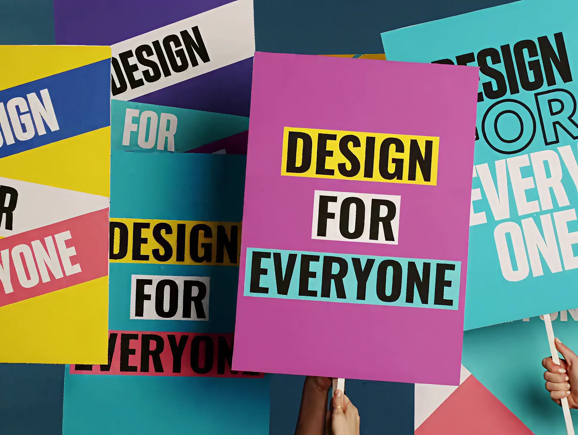 Colourful "Design For Everyone" poster signs, reflecting Canva's goal to make content creation accessible to all.