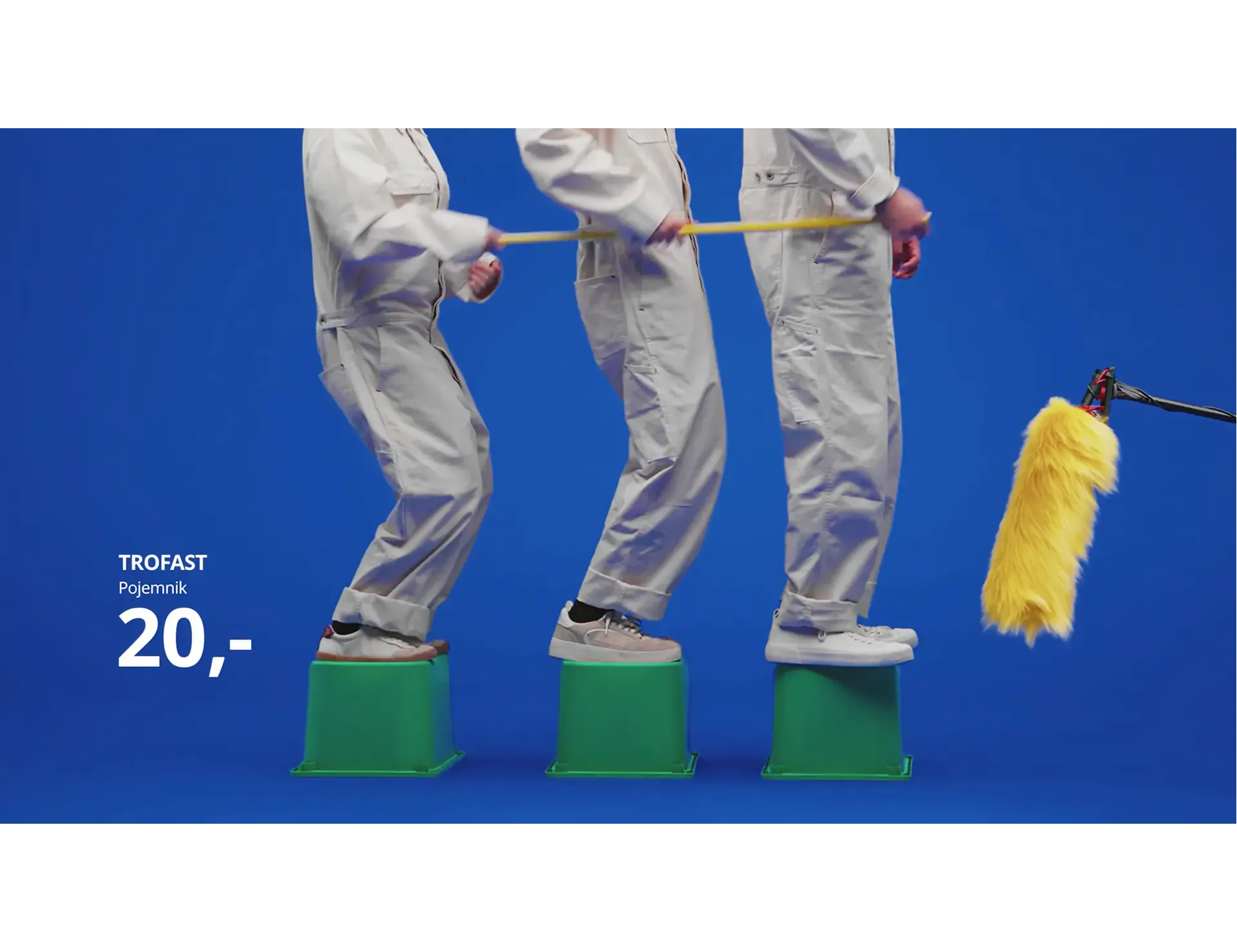 People in overalls on TROFAST boxes beside a boom microphone, recording for the Sound of IKEA campaign