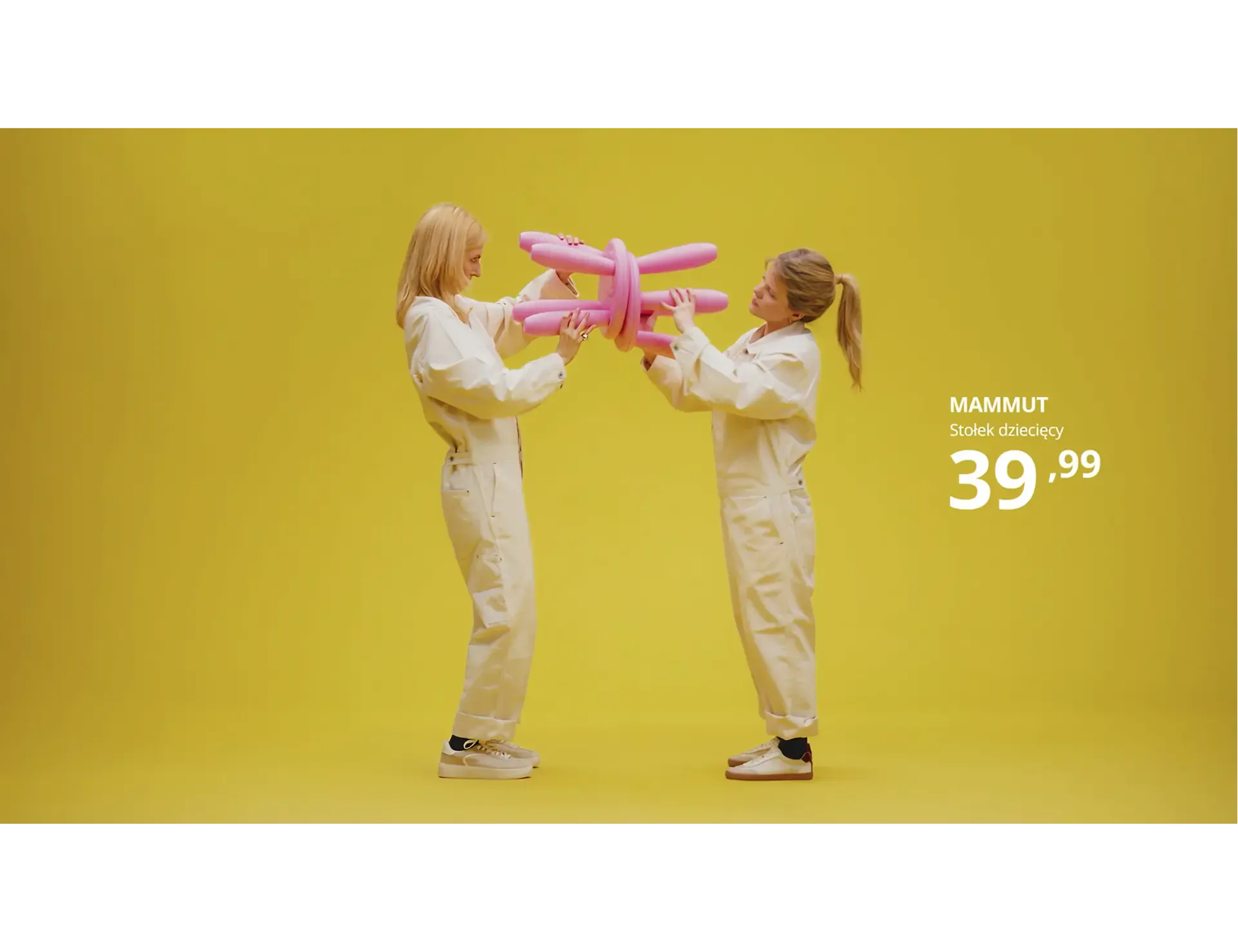 Two people holding a pink MAMMUT children's stool on yellow, from the Sound of IKEA campaign