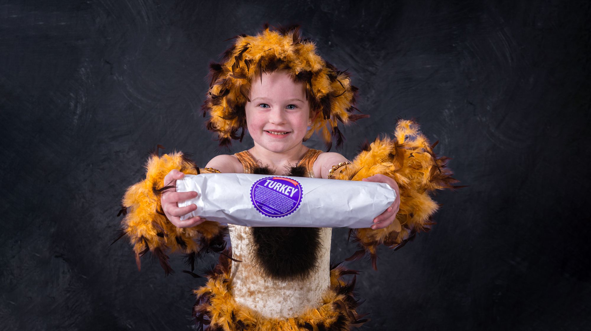 Youth girl dancer in a lion costume holding a Marianna's wrapped hoagie