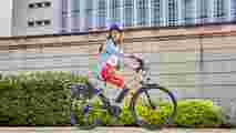 A Lady riding a Raleigh Motus ebike through the city 