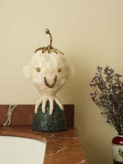 marble octopus sculpture next to a vase of sea lavender 