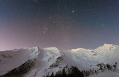 Sky of stars above snowy mountain
