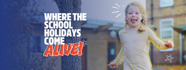 Smiling child running outdoors near brick buildings, with text reading "Where the school holidays come alive!" on the left.