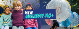 Three children smiling in colorful clothes, alongside a person inside a large inflatable bubble with the text "New Holiday HQ+" overlayed.
