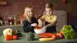 Children preparing food in a kitchen